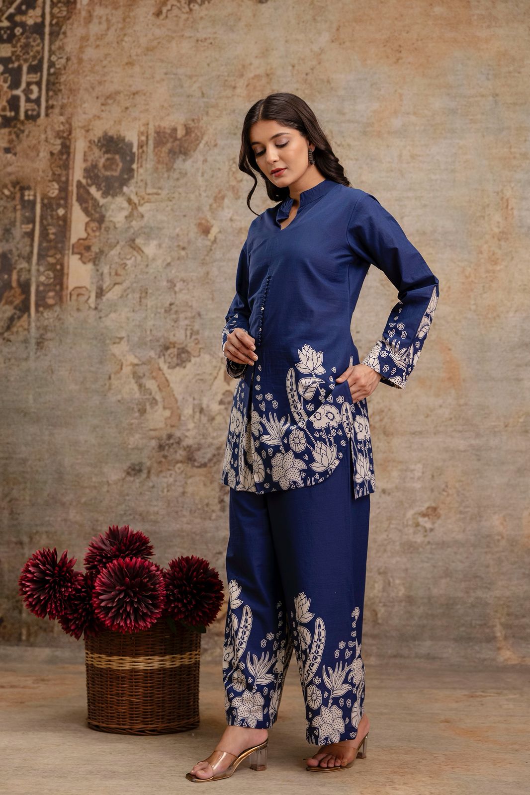 1. Side view of navy blue floral kurti co-ord set for women – cotton fabric  
2. Navy ethnic co-ord set with printed kurti and trousers – model side pose  
3. Stylish navy kurti set with floral border and full sleeves – relaxed fit  
4. Blue cotton co-ord set featuring block printed floral design – side angle  
5. Elegant navy blue ethnic wear set for women with handcrafted buttons  
6. Two-piece navy cotton outfit with floral motifs on kurti and pants – side pose  
7. Navy co-ord kurti set with front slit 
