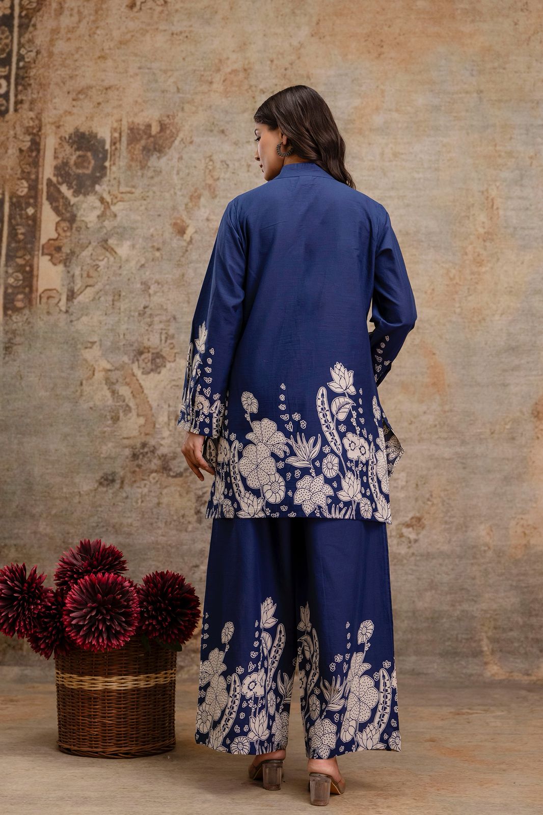 1. Back view of navy blue kurti and pant co-ord set with floral block print  
2. Navy cotton kurti set for women – rear angle with ethnic white motifs  
3. Full back pose of navy blue ethnic wear set with printed hem and sleeves  
4. Navy two-piece kurti and trousers set with floral design – rear view  
5. Stylish cotton kurti set in navy blue with traditional floral print on back  
6. Ethnic navy co-ord set with printed back and wide-leg pants for women  
7. Rear side of navy kurti and pant set with full 