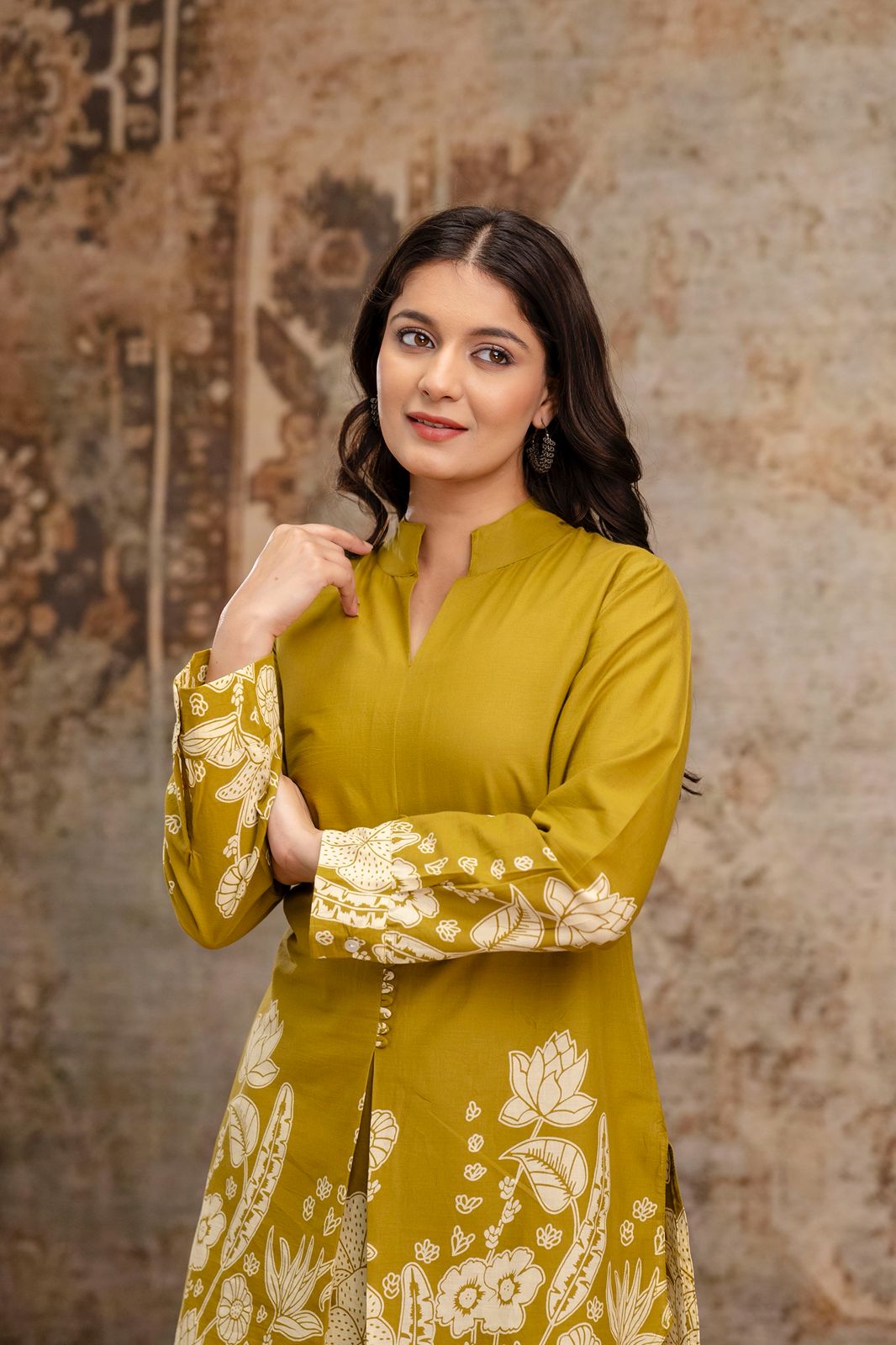 1. Close-up of mustard floral kurti with mandarin collar and printed sleeves  
2. Mustard cotton kurti for women with handcrafted button detailing – front pose  
3. Ethnic mustard kurti with white block floral print on cuffs and hem  
4. Model wearing mustard printed kurti – close-up view of neckline and sleeves  
5. Mustard kurti in breathable cotton fabric with elegant floral design  
6. Front close-up of mustard ethnic kurti with minimal makeup and earrings  
7. Stylish mustard kurti with floral sleeve 
