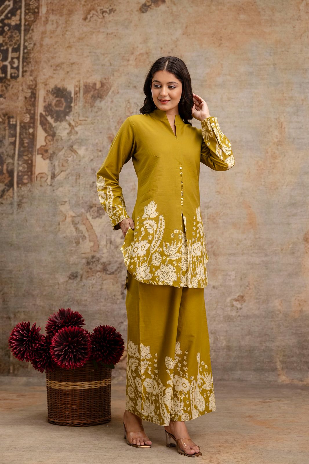 1. Mustard floral co-ord set with cotton kurti and wide-leg pants – side pose  
2. Side-front view of mustard kurti set with ethnic white print for women  
3. Mustard yellow kurti and pant set in cotton with floral block print  
4. Elegant mustard ethnic wear co-ord set – model in relaxed pose  
5. Stylish mustard printed kurti with full sleeves and front slit  
6. Mustard cotton two-piece set with floral prints on hem and cuffs  
7. Front side angle of mustard kurti and trousers – ethnic fashion  
8. Model